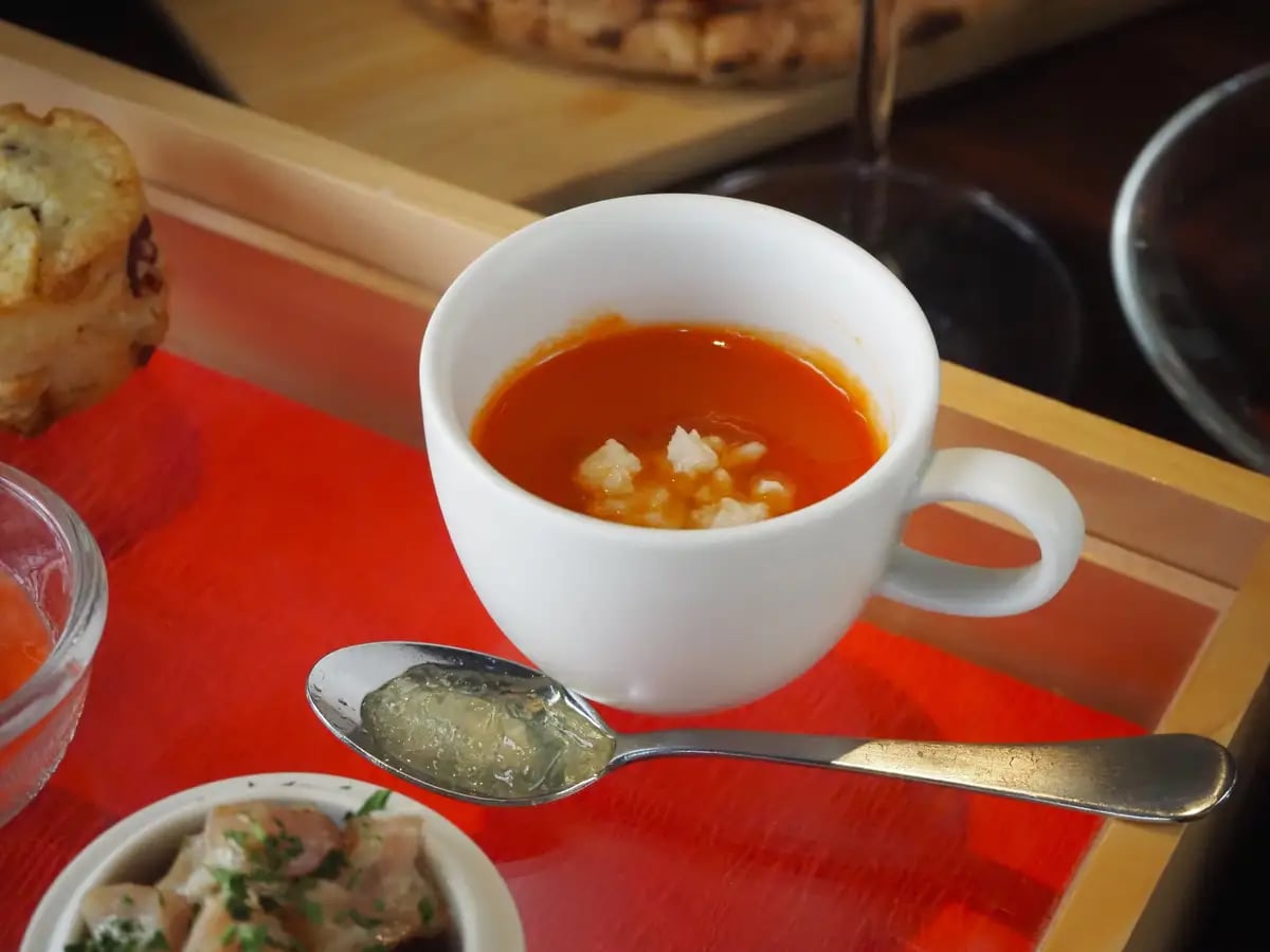 トマトのズッパ リコッタチーズとトマトコンソメジュレ じっくり煮込んでトマトの甘みを凝縮したスープに、リコッタチーズのコクと酸味を合わせました。別添えのトマトコンソメジュレを温かいスープに溶かすことで、トマトの旨みがさらに広がる一品です。
